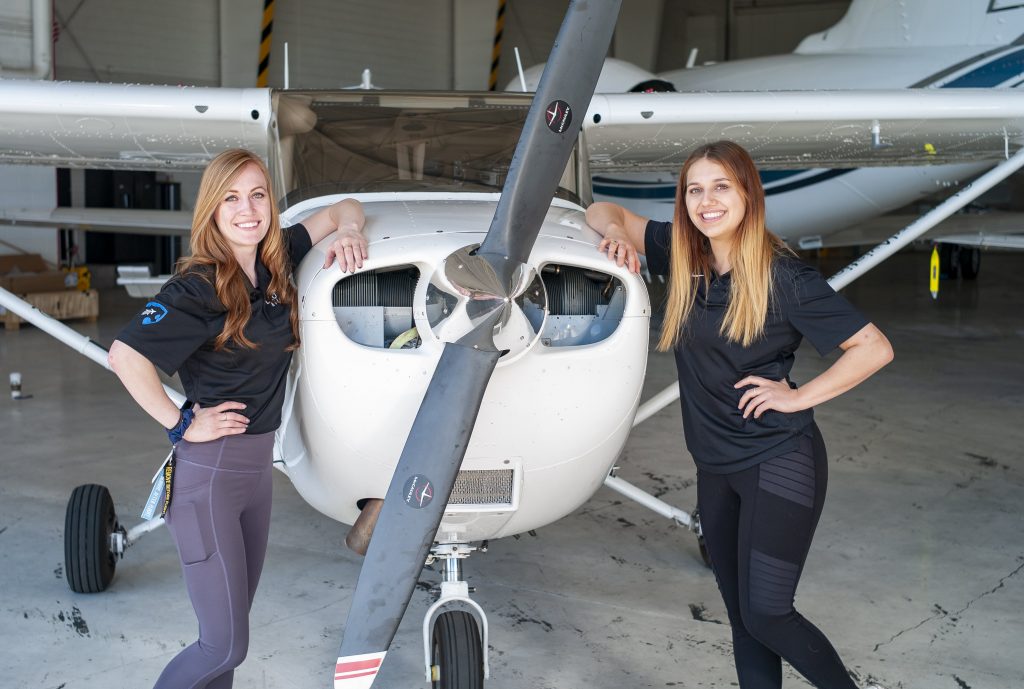 Leopard Aviation Students next to a plane 