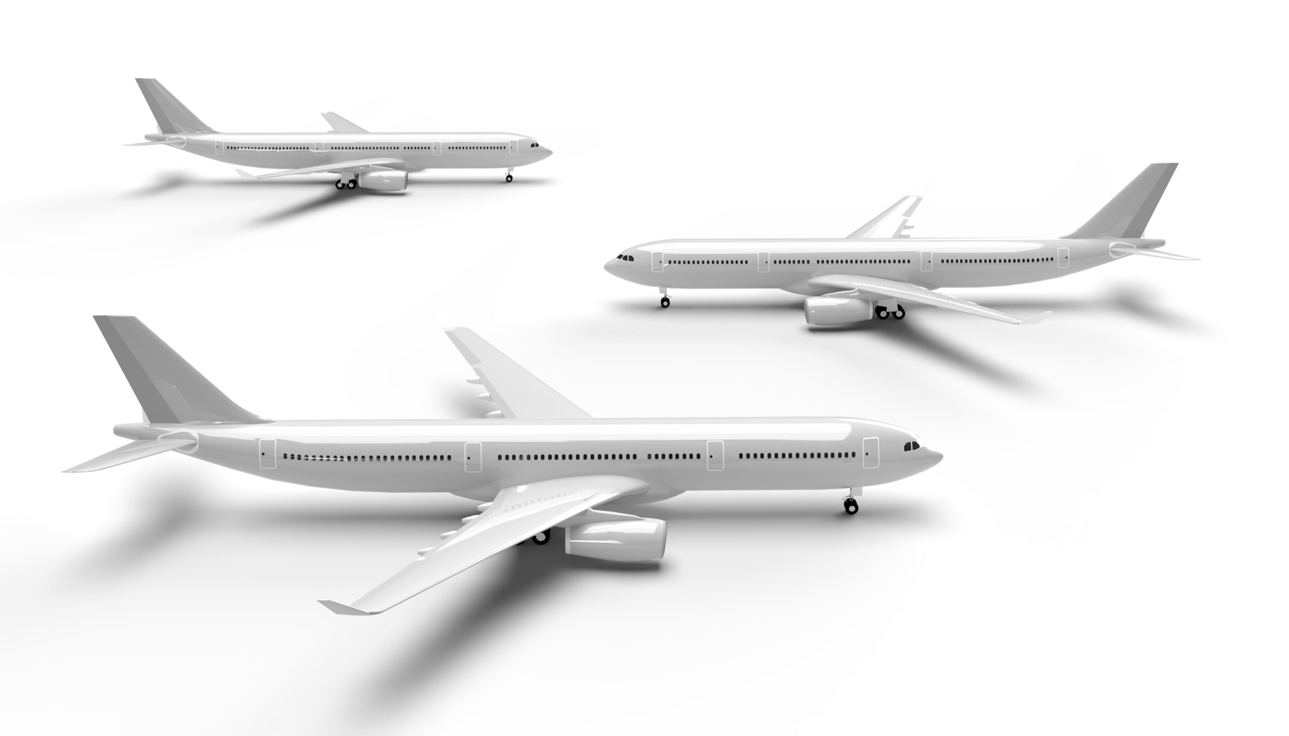 A comparison of three commercial aircraft of varying sizes: a small regional jet, a medium-sized single-aisle jet, and a large wide-body jet.