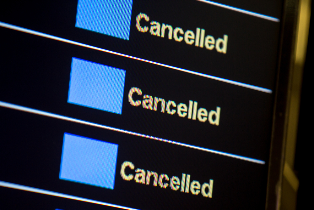 Pilot shortage image showing Canceled flight status showing on monitor