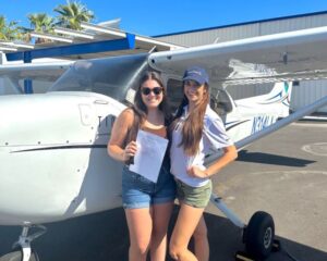 CFI awarding Leopard Aviation student with her commercial pilot certificate.