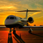 Image of a commercial jet on a runway with the sunset behind it.
